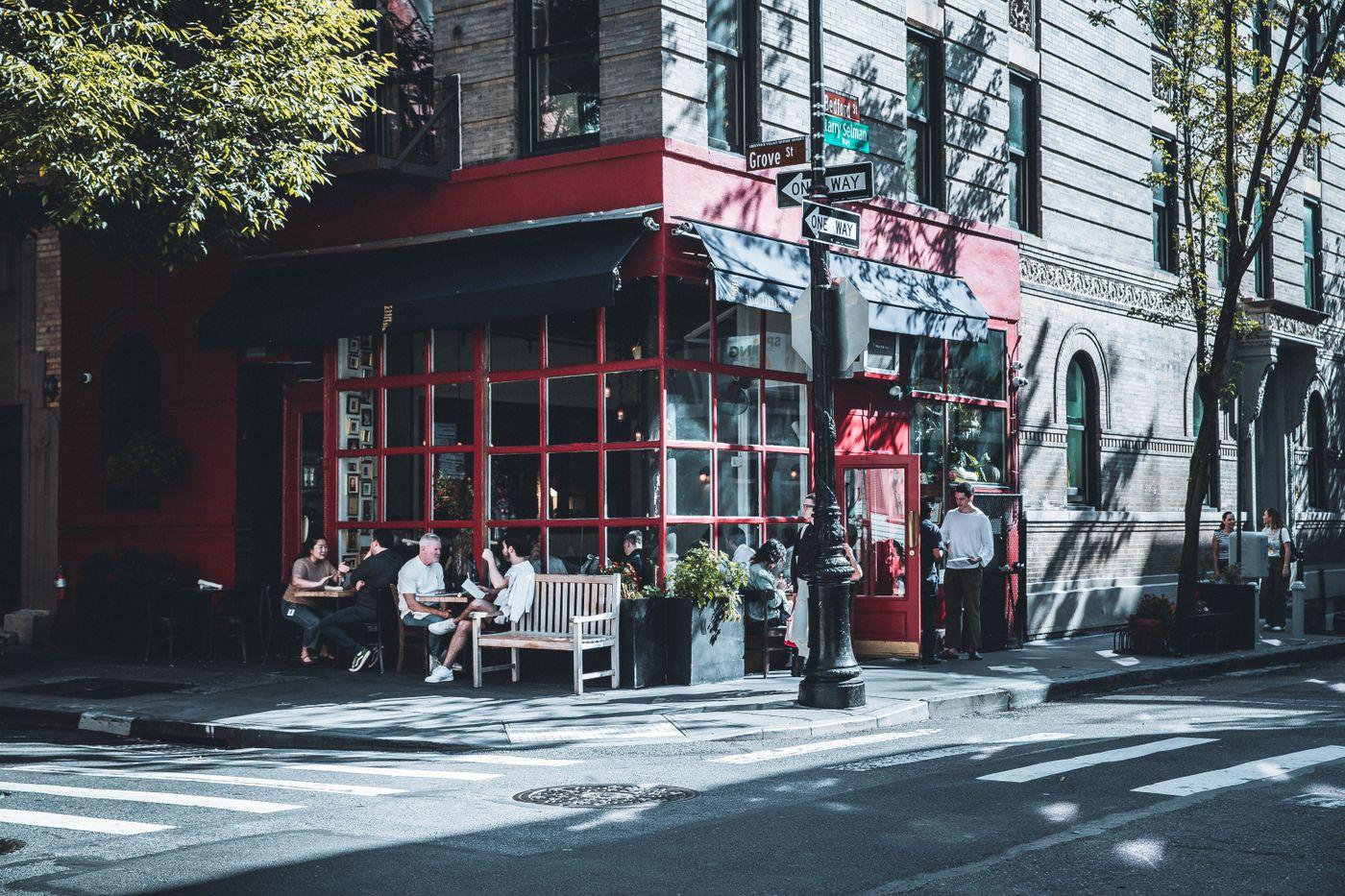 Outdoor cafe on a New York City street corner, illustrating a business with a real location and customer journey.